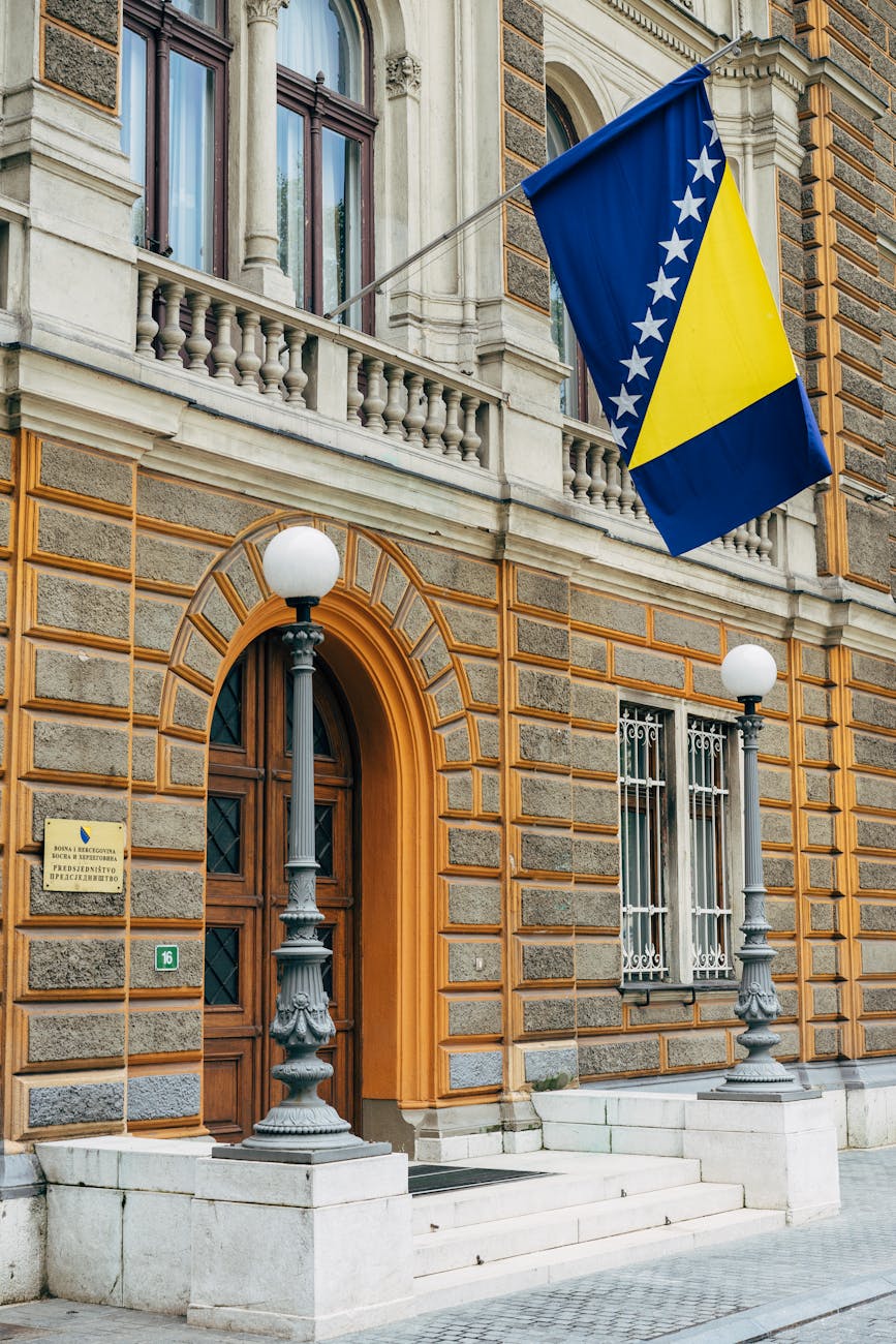 blue and yellow flag on a brown concrete building